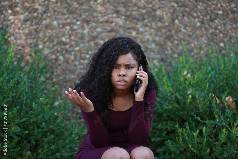 Black female frowning and gesturing during phone conversation Black female frowning and gesturing during phone conversation