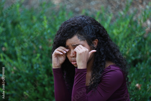 Black woman crying in park