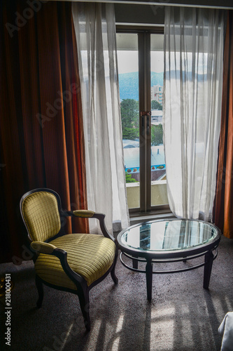 Chair and glass table in vintage room photo