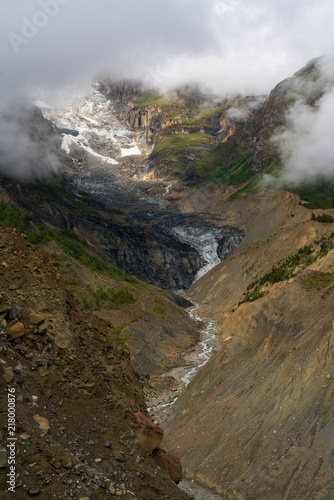 Sunlight peaks through the clouds on the Gangapurna glacier in the Himalayas  © Jesse