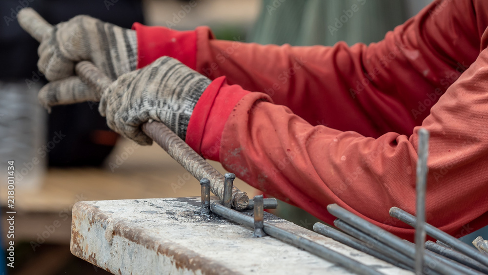 close up hand construction worker use glove bundle steel bar in construction site close up hand construction worker use glove bundle steel bar in construction site