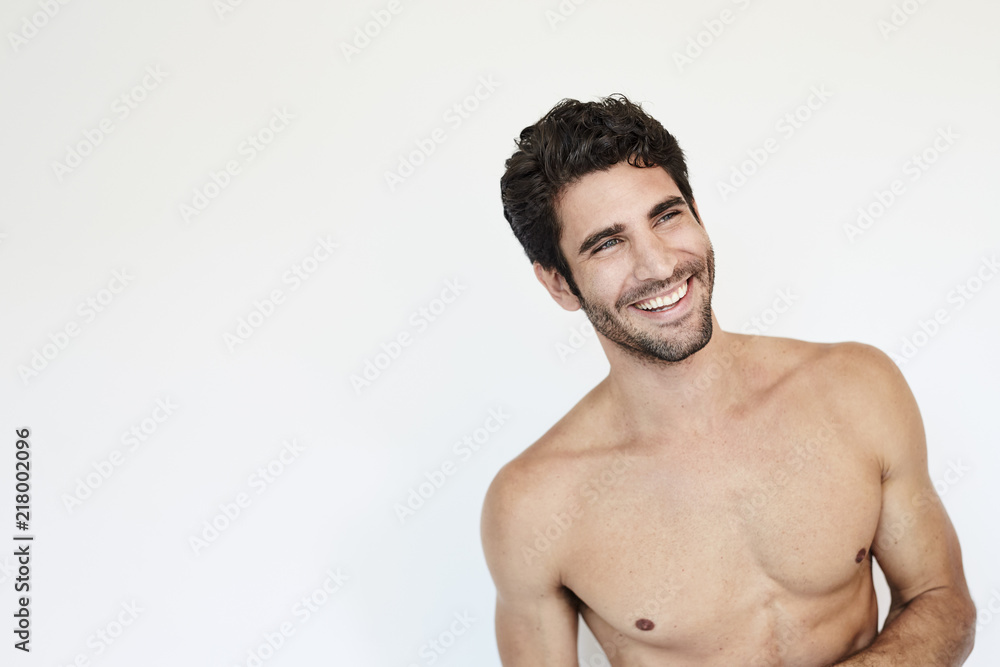 Fototapeta premium Hunky topless guy smiling in studio