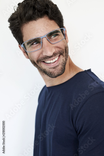 Guy in blue t-shirt and glasses, smiling © sanneberg