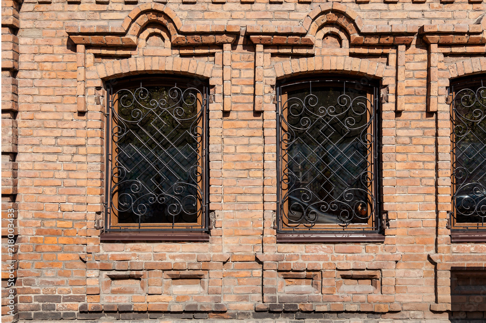Close-up of a two  old windows  in old house a mansion made of old brick