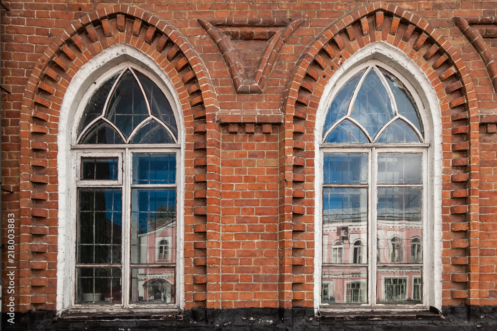 Close-up of a two  old windows  in old house a mansion made of old brick