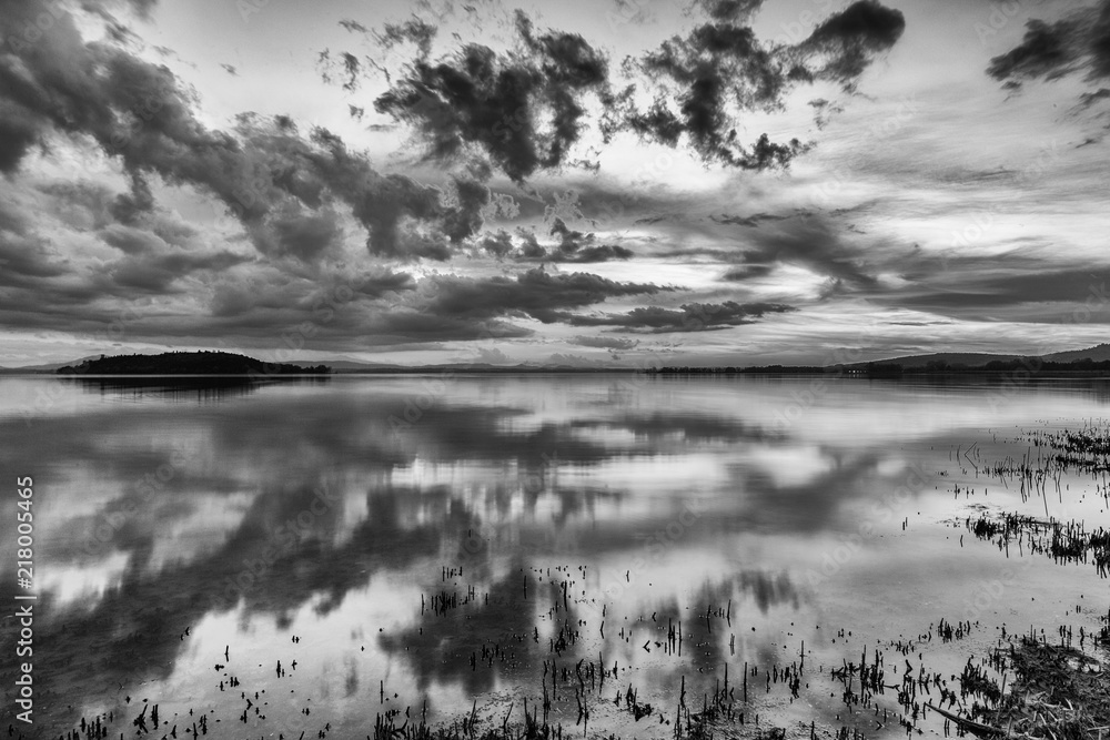 Fototapeta premium Perfect and symmetric clouds and islands reflections on a lake, making abstract shapes