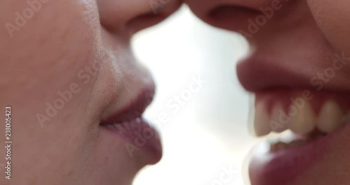 Close-up of Lesbian couple mouth talking to each other, gossiping and in conversation