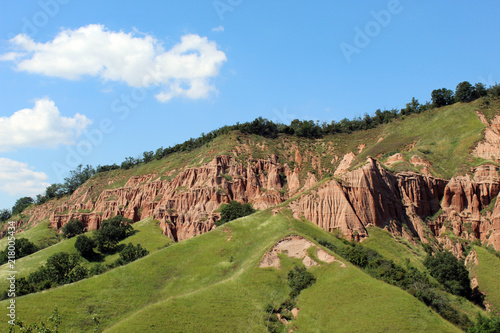 Scenic view with the Red Ravine, a unique natural monument with impressive craggy reddish badlands relief near Sebes city, Alba county, Romania.