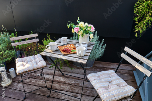 Fototapeta Vintage outdoor coffee table in cafe wooden terrace.