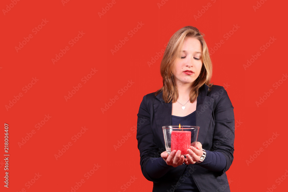 Pretty woman with candle in red Pretty woman with candle in red