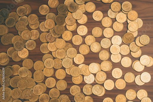 Stack of coin on wooden working table  business and finance concept.