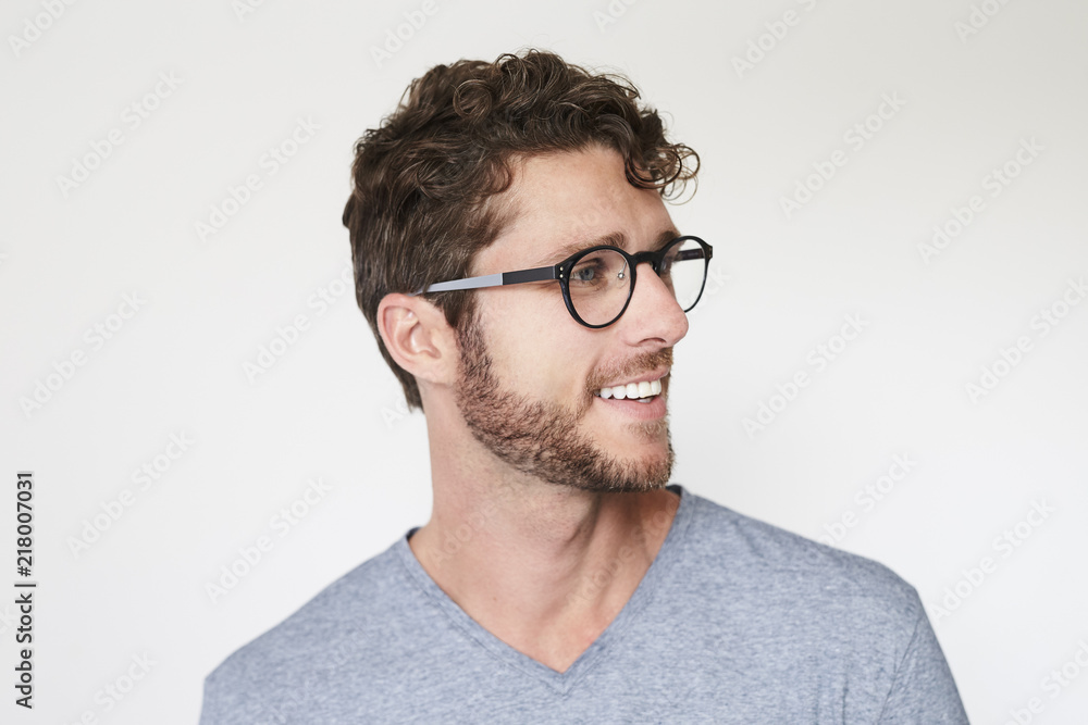 Smiling handsome guy looking away in grey Smiling handsome guy looking away in grey