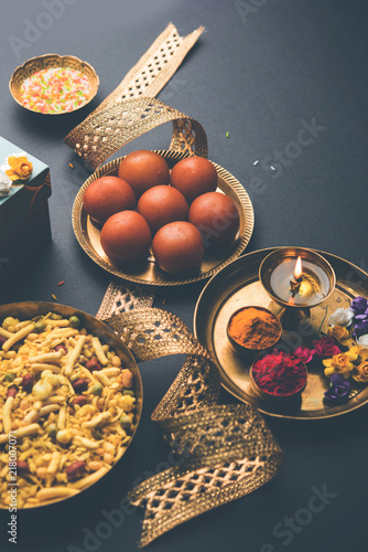 Raksha bandhan Festival : conceptual Rakhi made using plate full of Gulab Jamun sweet with band and Pooja Thali. A traditional Indian wrist band which is a symbol of love between Brothers and Sisters photo