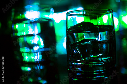 colored lighting of glasses in the night club bar photo