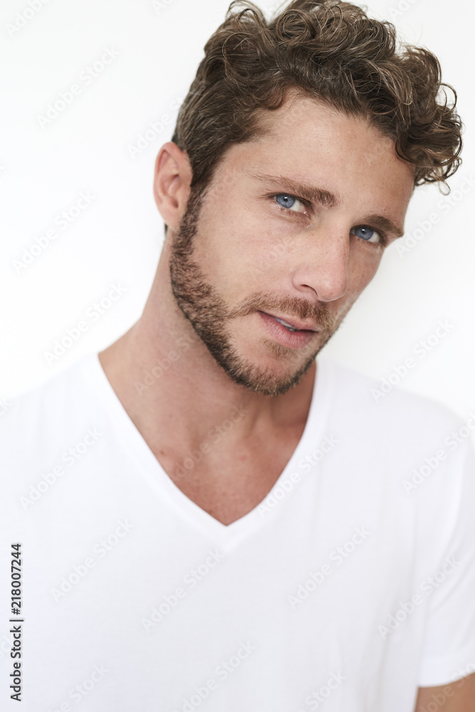 Fototapeta premium Boy with blue eyes and stubble, portrait