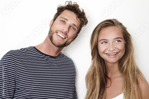 Happy young couple in white studio