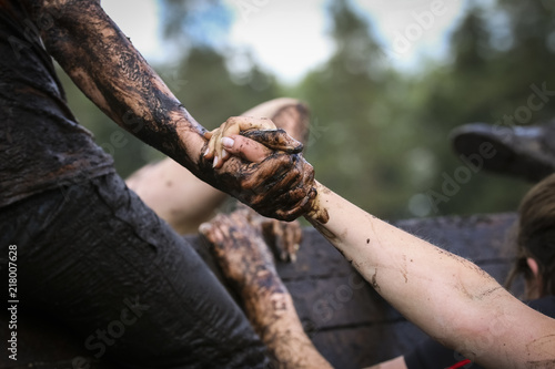 Mud race runners during extreme obstacle races photo