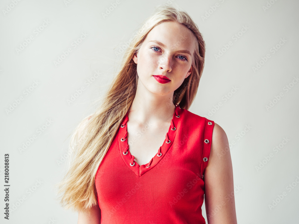 Red dress woman with blonde long hair and beauty red lipstick Red dress woman with blonde long hair and beauty red lipstick