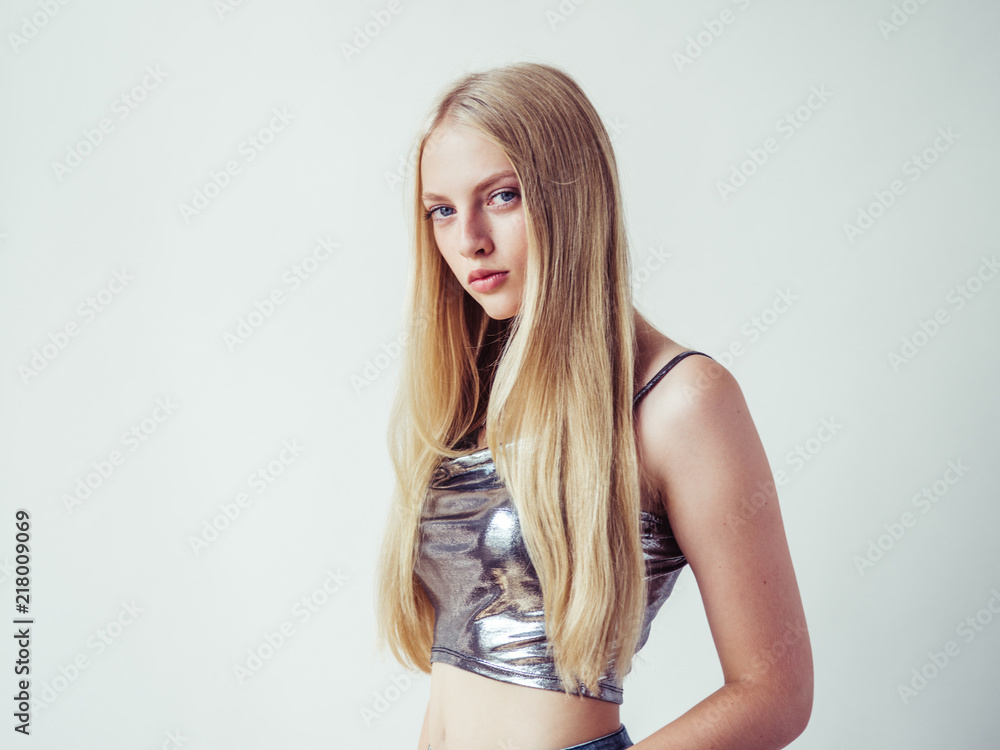 Blonde long hair woman girl in silver dress over white background Blonde long hair woman girl in silver dress over white background