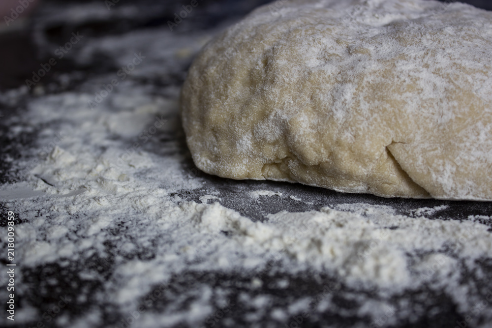 Unbaked dough on the table with the flour around Unbaked dough on the table with the flour around