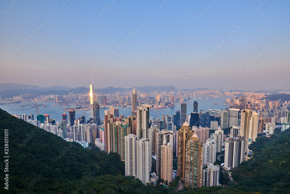 Hong Kong city skyline view from Victoria peak with skyscrapers buildings at sunset.