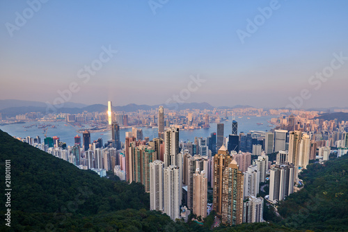 Hong Kong city skyline view from Victoria peak with skyscrapers buildings at sunset.