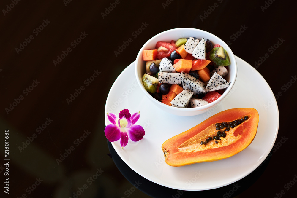 Fruit salad on a  black background with space for text.