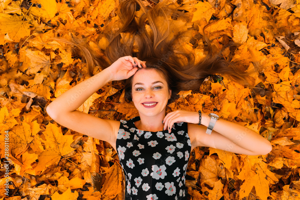 Beautiful and cute girl with long hair in autumn park on the sunny day ...