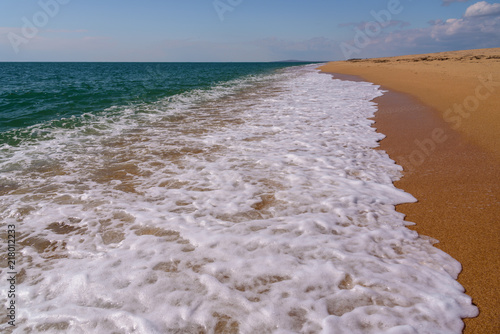 Wild beach of the Black Sea in Crimea against the blue sky