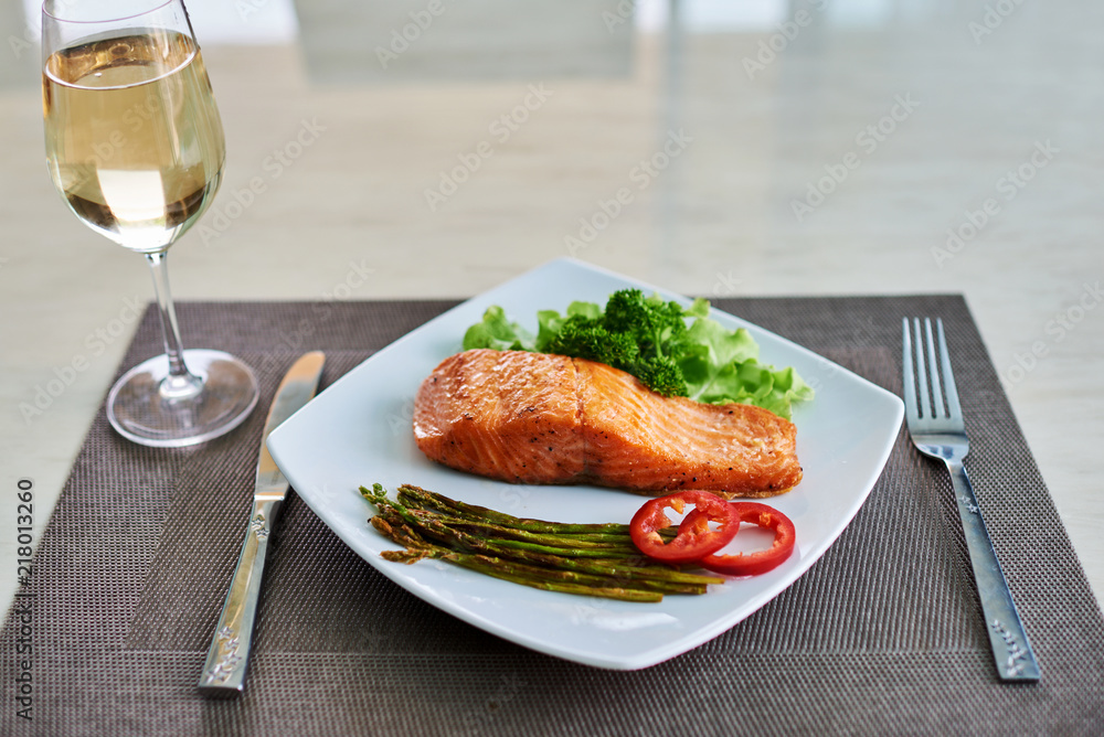 Baked salmon garnished with asparagus and peppers  with herbs.