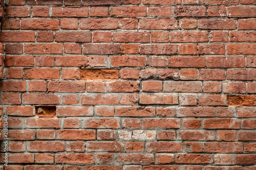 Red old brick wall of an building, background texture of a brick