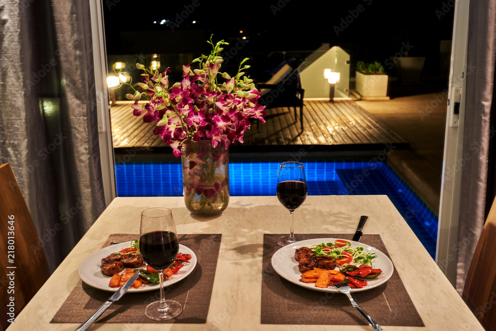 Romantic dinner in a villa overlooking the pool.