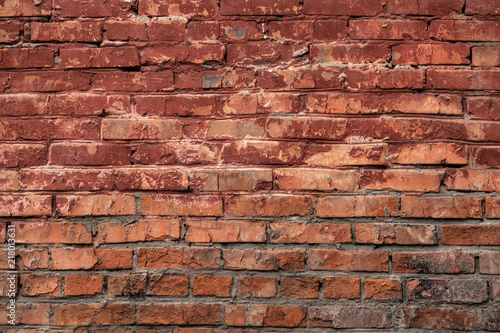 Red old brick wall of an building, background texture of a brick