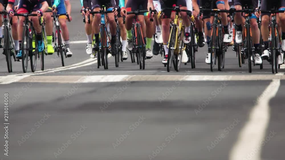 Telephoto shot of bicycle wheels as riders race towards camera.