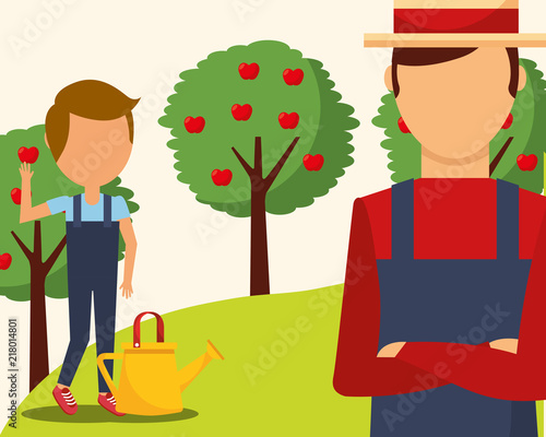 gardeners man and boy with watering can and apple trees