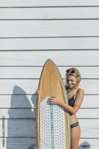 Woman Surfer Holding a Board