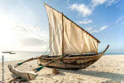 A Dhow boat on the beach. Sailing boat on the shore. photo