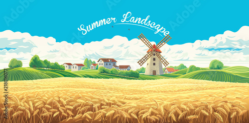 Rural summer landscape with the village and the mill and a large field of wheat. 
