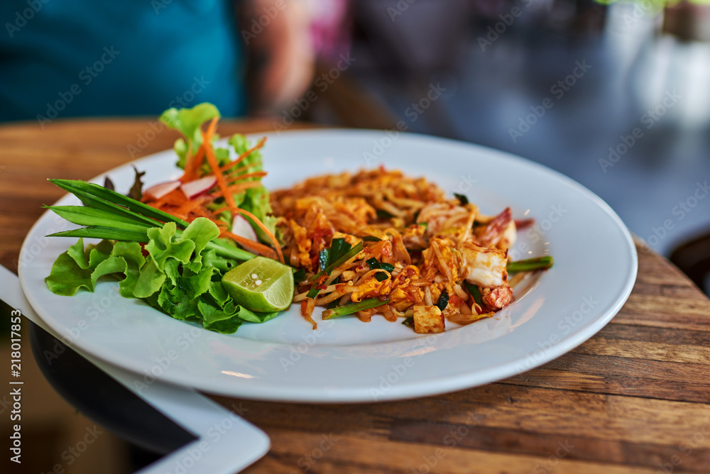Vegetarian Thai food, stir-fried rice noodles, on wooden background Vegetarian Thai food, stir-fried rice noodles, on wooden background