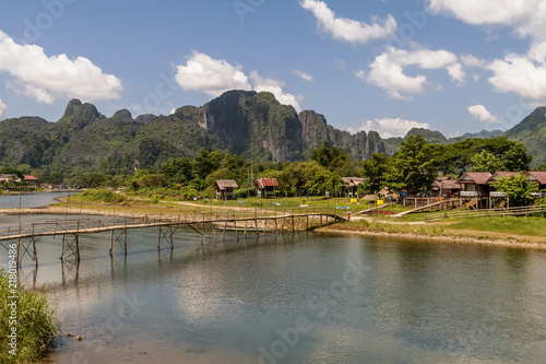 The beautiful landscape with bamboo bridge on the Nam Song river in Vang Vieng, Laos