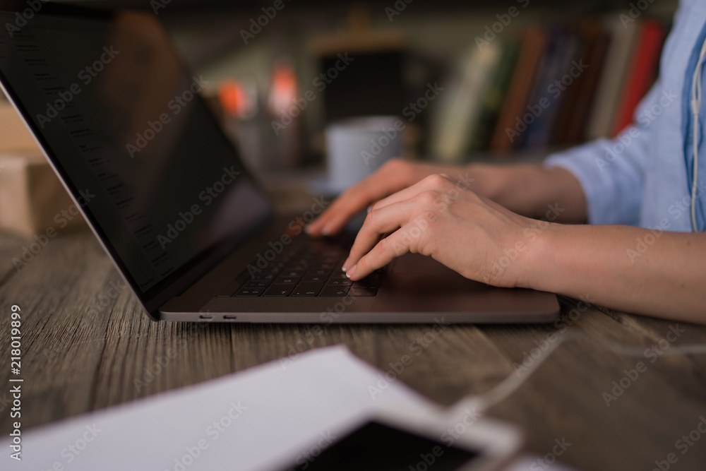 Side view and close up of woman's hands typing on laptop keyboard. Woman's hands pressing keys on a laptop keyboard trying to access data. Female working with laptop at home. Selective focus. Side view and close up of woman's hands typing on laptop keyboard. Woman's hands pressing keys on a laptop keyboard trying to access data. Female working with laptop at home. Selective focus.