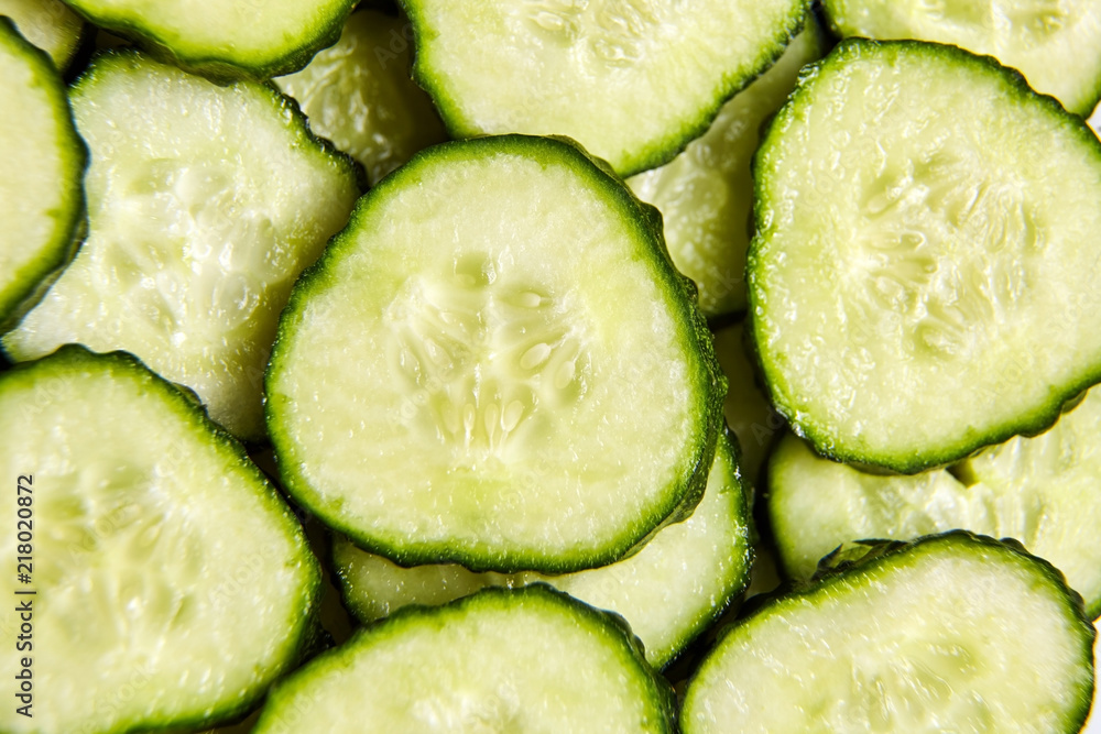 Green slices of cucumber as background Green slices of cucumber as background