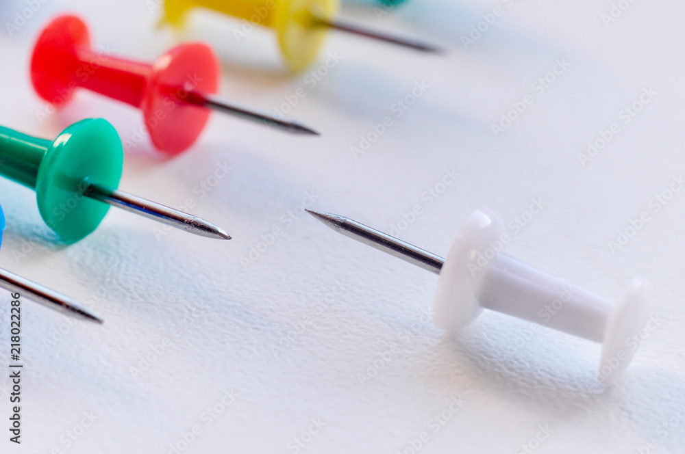 Multicolored clerical needles, needles on white background Multicolored clerical needles, needles on white background