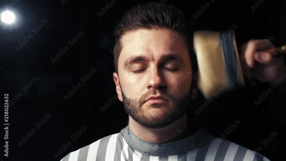 Hairdresser cleans man's neck after cutting hair Hairdresser cleans man's neck after cutting hair
