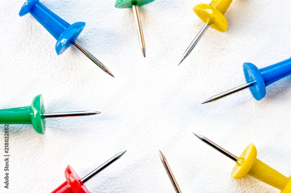 Multicolored clerical needles, needles on white background Multicolored clerical needles, needles on white background