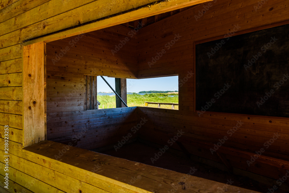 Φωτογραφία The view of lake Takern, Sweden, through the lower part of a public bird watching tower on a sunny summer day