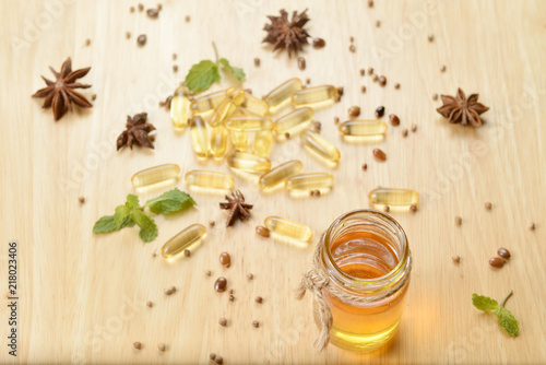 Fish oil on bottle on brown wooden background with many fish oils.