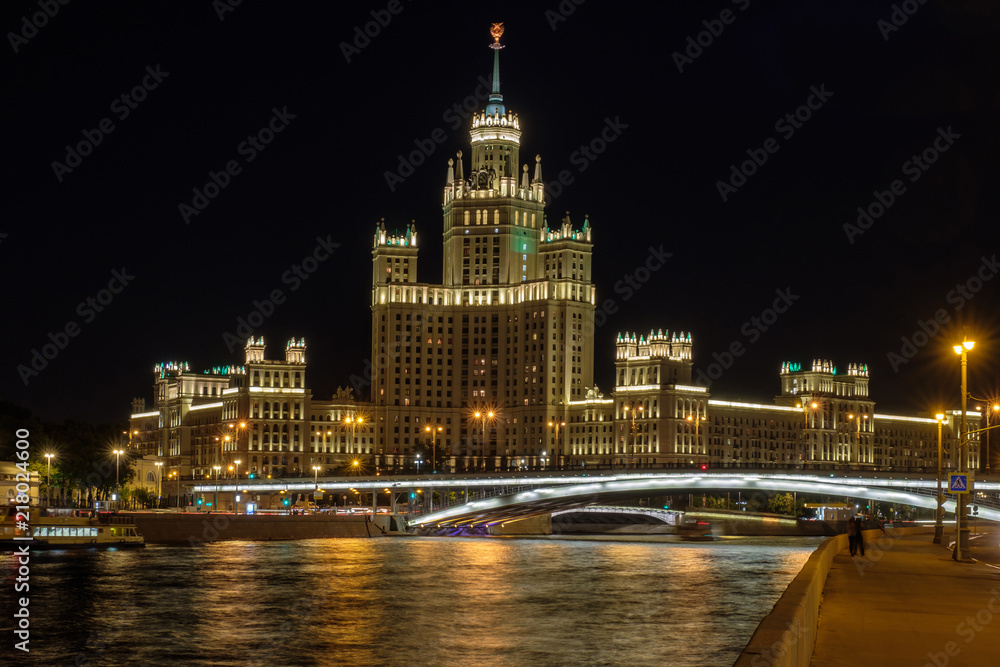 Moscow city landscape with night view on skyscraper on embankment river.