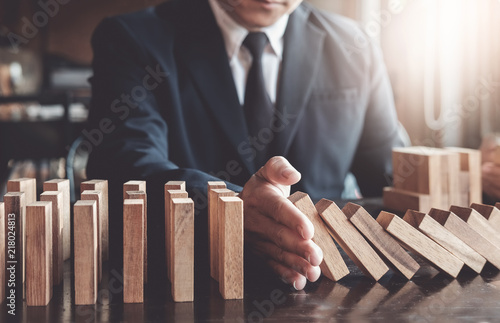 Business risk control concept, Businessman protect wooden block fall to planning and strategy in risk to business Alternative and prevent Fototapete