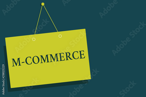 Writing note showing M Commerce. Business photo showcasing commercial transactions conducted electronically by mobile phone Yellow board wall communication open close sign gray background. photo